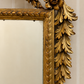 Italian giltwood mirror with urn crest, carved foliage and scroll feet  Close up of rosette 
