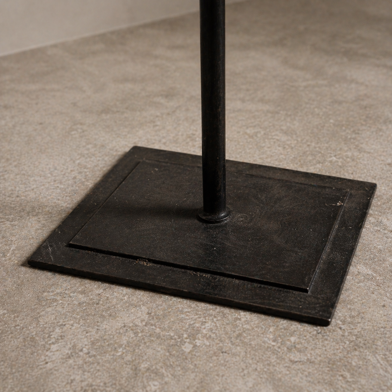 heavy forged iron base of vintage lectern showing layered metal construction