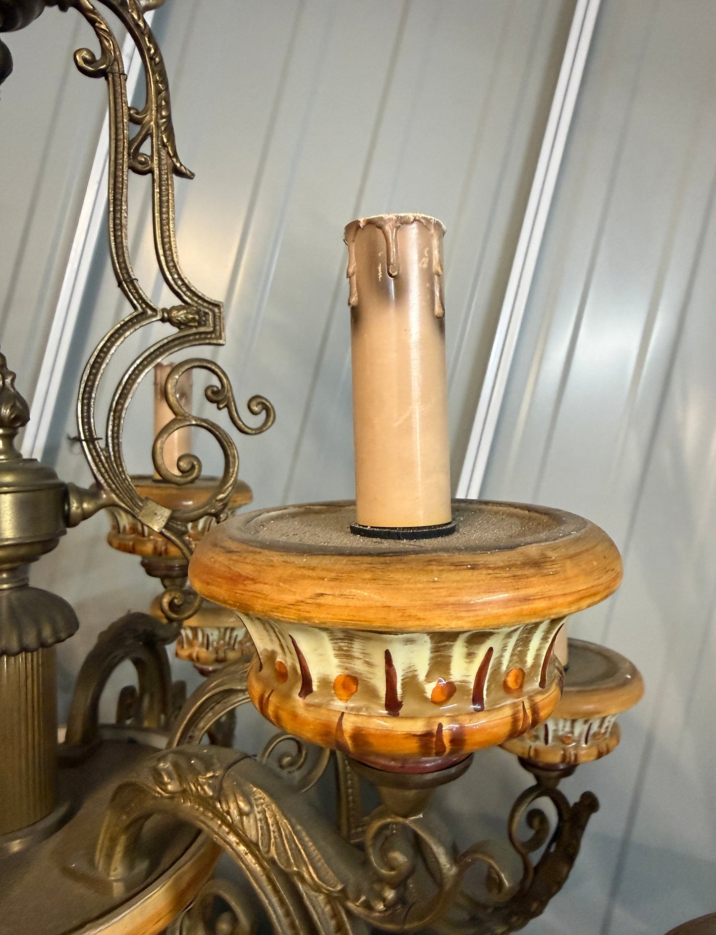 Close-up of an ornate Italian vintage chandelier with intricate details of the antiqued looking candle to hold the bulb