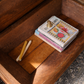 French rustic coffee table converted from antique dough table. Styled with books and decor to show storage ability. 
