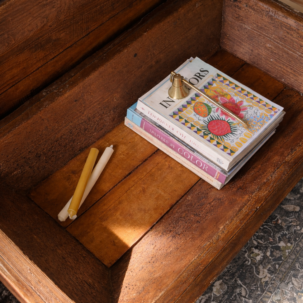 French rustic coffee table converted from antique dough table. Styled with books and decor to show storage ability. 