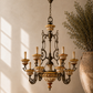 Large Italian ceramic chandelier hanging from ceiling in rustic room