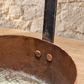 

Interior of the copper ladle showing aged deposits and two copper rivets