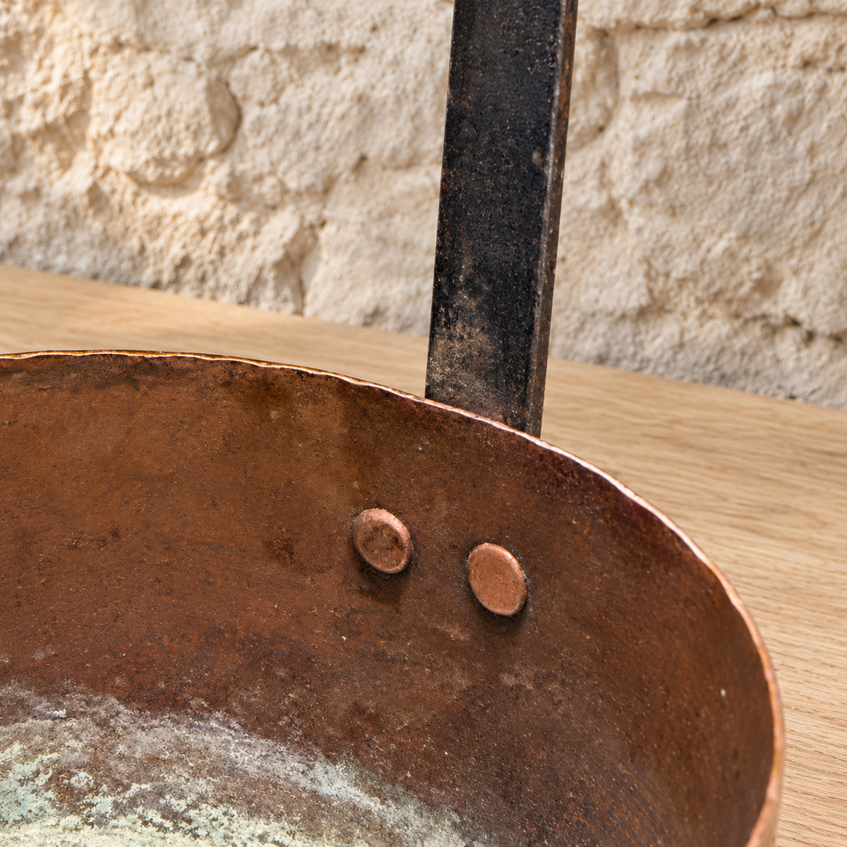 

Interior of the copper ladle showing aged deposits and two copper rivets