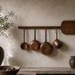 French bread panel antique with copper pots hanging from it in kitchen