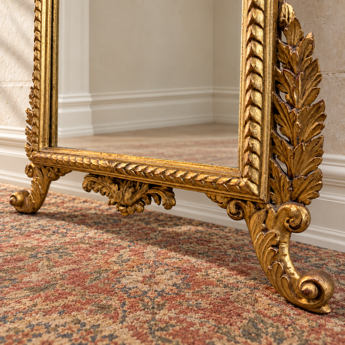 Italian giltwood mirror with urn crest, carved foliage and scroll feet