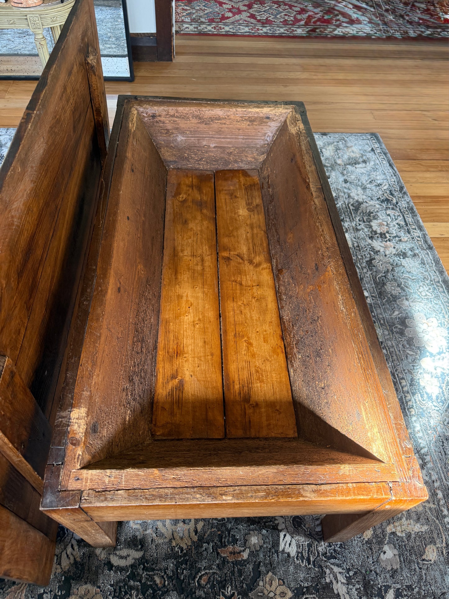 Inside the French antique dough table converted to a coffee table showcasing the internal depth and angles and patina perfect for storage of magazines games and other accessories you might want to keep hidden for styling purposes