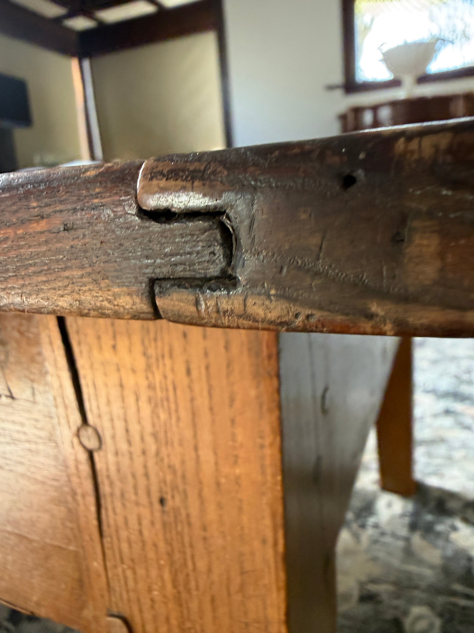 Construction detail shows antique French craftsmanship of the joints in this antique French pine coffee table converted from a dough table