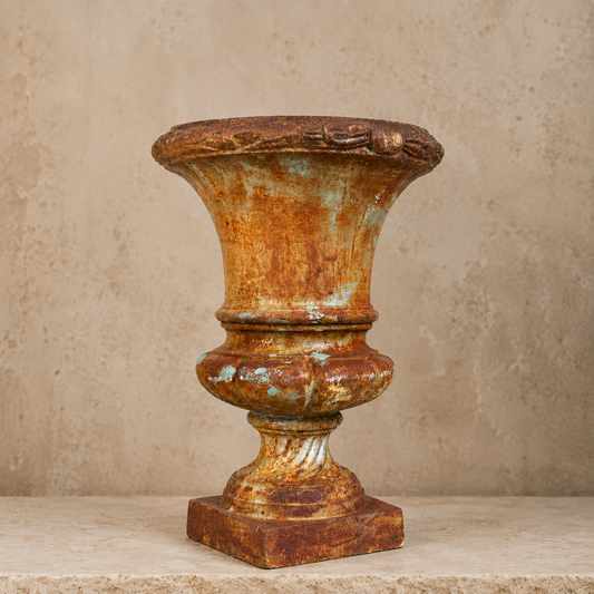 Rusticated urn with a textured surface on a neutral background. French antique. 