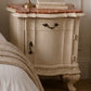 Vintage-style nightstand with marble top and candle holder in a bedroom setting. Italian marble bedside tables with red marble.  