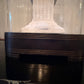 Decorative white column on a black base with a blurred background antique French cloche base 